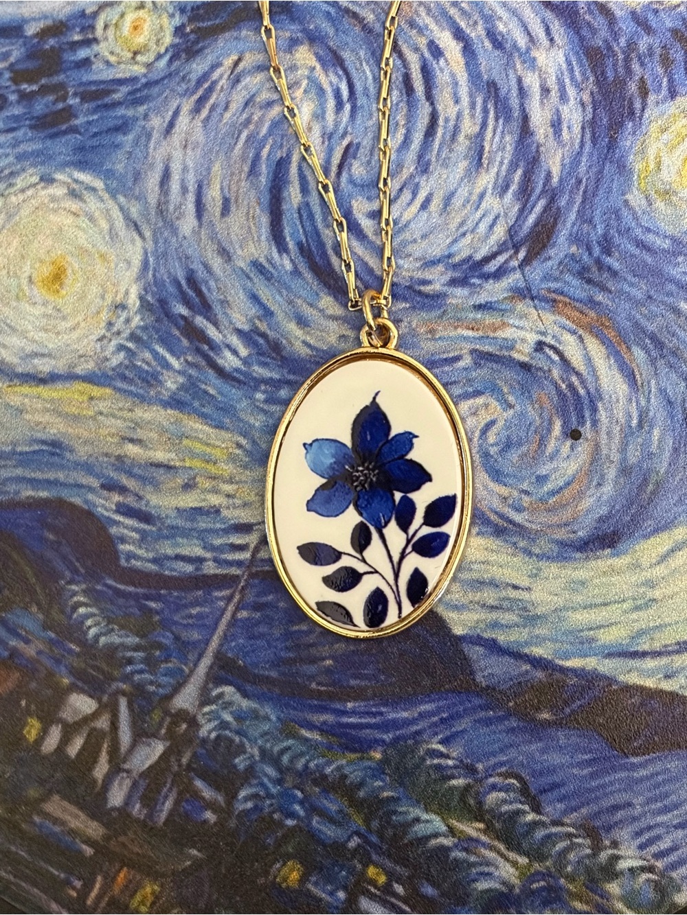 Gold Oval Pendant Necklace with Blue Floral Motif